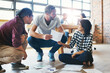 © Nikish Hiraman/peopleimages.com - Meeting, discussion and business people with documents in office for growth, graphs or statistics. Photography agency, diversity and employees on floor for collaboration, planning or project budget