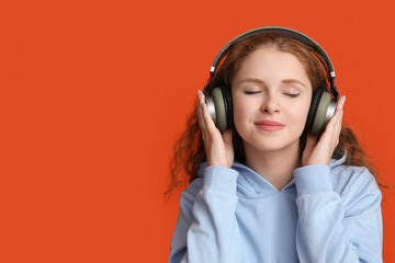 Wall Mural - Portrait of relaxed young woman listening to music on red background