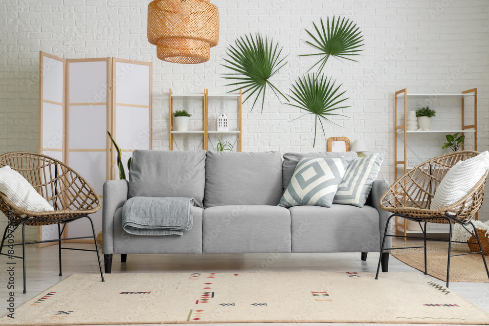 Interior of living room with sofa, armchairs and folding screen