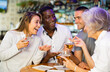 © JackF - View on the young Interracial couple talking to diversse group at a bar