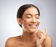 © Flashizzle/peopleimages.com - Skincare, woman and smile for cream, cosmetics and routine facial treatment. Spa, wellness and skin glow dermatology on white studio background with model, aesthetic and luxury collagen moisturizer