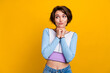© deagreez - Photo of doubtful unsure lady dressed shirt arms chin looking empty space isolated yellow color background