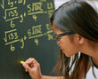 © peopleimages.com - Girl, writing solution and blackboard with chalk as genius for learning, education and childhood development. Student, child and classroom for tuition, growth and knowledge in assessment for math