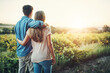 © Lyndon/peopleimages.com - Back, hug and couple in sunrise, outdoor and together with care, love and date for anniversary in park. Morning, partner and person with embrace, nature and peace in field and relax in Texas in farm