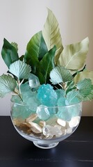 Wall Mural - A glass bowl filled with sea glass and green leaves sits on a dark surface