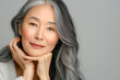 © MVProductions - Japanese adult woman with smooth healthy face skin. Beautiful aging mature asian woman with long gray hair and happy smiling touch face. Beauty and cosmetics skincare advertising concept.