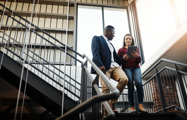 Fototapete - Business people, tablet and discussion on stairs in office with talking for project management and client briefing. Professional, employees or walking with digital tech for teamwork on creative ideas