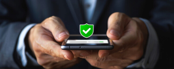 Poster - A man is holding a cell phone with a green shield on it. The shield is a symbol of protection and security