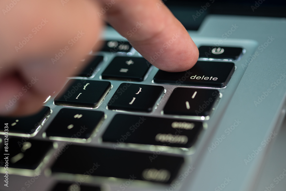 Delete Button Computer Finger of the computer user, he presses the delete button on the ...