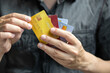 © Photo Sesaon - Man holding several credit cards and he is choosing a credit card to pay and spend Payment for goods via credit card. Finance and banking concept