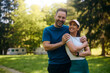 © Drazen - Portrait of happy athletic couple in park.