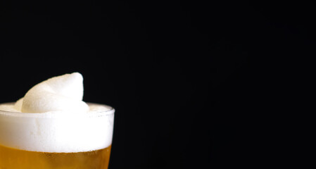 full glass of beer and foam isolated on black background banner close up view with blank space