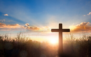 Wall Mural - silhouette of catholic cross at sunrise background.