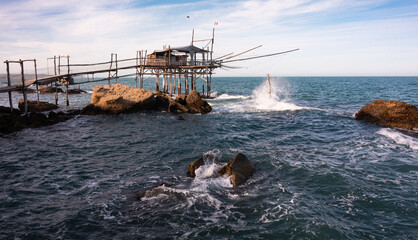 Wall Mural - Traditional wooden fishing house with a net near sea coast