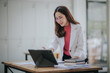 © Witoon - Attractive Asian businesswoman working at modern office with balance sheet documents. Accounting