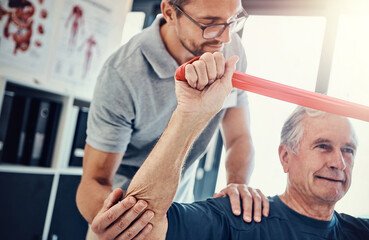 Canvas Print - Healthcare, physiotherapist and old man with resistance band, stretching and senior care rehabilitation. Physio, caregiver and elderly patient for mobility training, exercise and help in retirement.