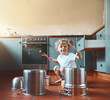 © peopleimages.com - Smile, child and fun with pots in kitchen for creative drums, music or sound as musician of childhood learning. Happy, boy and playing on fantasy instrument of sensory game activity for development