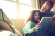 © peopleimages.com - Home, father and child with tablet on sofa for game, streaming cartoon or movies in lounge. Family, dad and girl with digital for elearning, education or online application for reading ebook on couch
