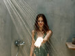 © SHOTPRIME STUDIO - Refreshing outdoor shower on a sunny day for a woman in a vibrant green bathing suit