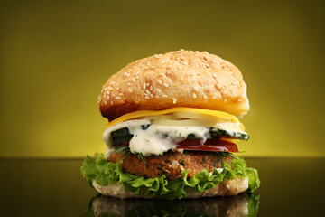 Wall Mural - Delicious vegetarian burger on mirror surface against olive background