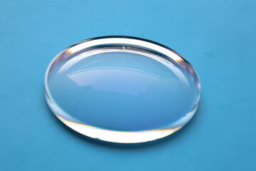 Sticker - Glasses lens on blue table background 