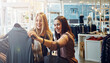 © peopleimages.com - Fashion, shopping and friends with decision for clothes, sales and discount promotion at mall. Smile, retail shop and customer with fabric at boutique for purchase choice with women or girls laughing