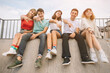 © anatoliycherkas - Summer holidays and teenage concept - group of smiling teenagers hanging out outside.