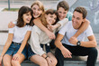 © anatoliycherkas - Summer holidays and teenage concept - group of smiling teenagers hanging out outside.