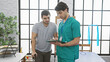 © Krakenimages.com - A male physiotherapist consulting with a male patient in an indoor rehabilitation clinic.