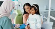 © peopleimages.com - Child, dentist or education of brushing teeth in office or family friendly demonstration of tooth hygiene. Girl, parent or pediatric orthodontist with dental model to brush or lesson on mouth care