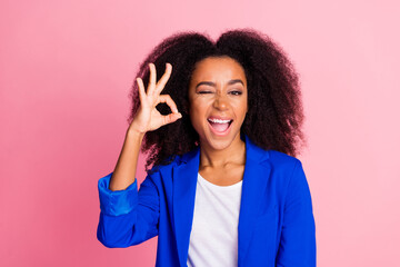 photo of satisfied pleasaant nice woman with perming coiffure wear blue jacket show okey winking eye