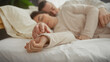 © Krakenimages.com - A couple in an intimate embrace sleeps peacefully in a cozy bedroom setting, depicting love and togetherness.