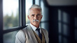 © LightoLife - Confident senior businessman with white hair and mustache standing by window in a modern office. Professional and executive portrait.