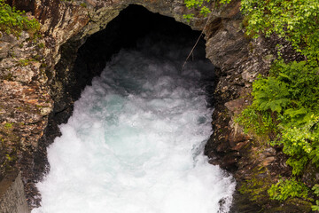 Wall Mural - Norway Tyntflossen waterfall on a cloudy summer day