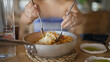 © Krakenimages.com - Young hispanic woman mixing food with cutlery at the restaurant