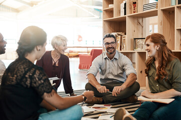 Group, circle or business people sitting on floor for collaboration, documents and notes for ideas. Teamwork, huddle or meeting with leader for company plan, talking with graph for strategy in office