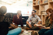© peopleimages.com - Group, circle or business people sitting on floor for collaboration, documents and notes for ideas. Teamwork, huddle or meeting with manager for company plan, discussion for strategy in office
