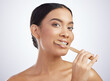 © Flashizzle/peopleimages.com - Portrait, dental or girl brushing teeth in studio for wellness, fresh breath or oral care on white background. Face, toothpaste or model with eco friendly bamboo toothbrush for mouth, gum or cleaning