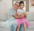 © peopleimages.com - Grandfather, granddaughter and portrait with hug, love and relax in home as family for bonding. Elderly man, girl and smile in living room with trust, care and skirt on sofa for happiness and fun