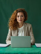 © Vladimir - A woman with laptop on green background. A person with a strong personality