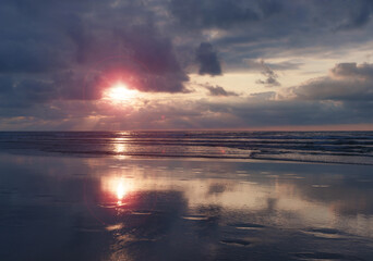 Wall Mural - Sunset on the beach. Sunset on the Zurriola beach, city of Donostia San Sebastian, Basque Country.