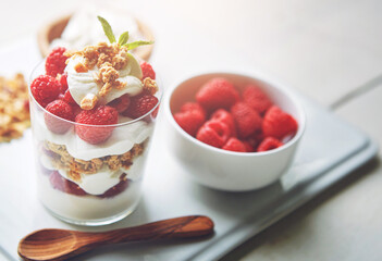 Home, bowl and strawberry with yogurt for healthy or nutrition and diet with ingredient for fruit salad. Glass, smoothie and sweet flavor for snack or lunch with fresh food for self care or wellness