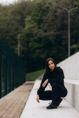 Wall Mural - Fitness, sports and woman doing a stretching her arms before a workout or training outdoor in nature. Health, wellness and girl athlete doing a warm up exercise for her muscles, joints and body.