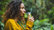 © NooPaew - Person drinking a green smoothie outdoors
