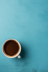 Wall Mural - Cup of coffee on saucer isolated on blue background