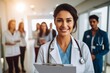 © olegganko - Smiling Female Nurse Leading Group of Medical Professionals Down Hospital Corridor