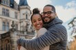 © Markus Schröder - Portrait of a joyful multicultural couple in their 30s wearing a thermal fleece pullover on backdrop of a grand castle
