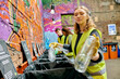 © LIGHTFIELD STUDIOS - A woman standing beside a vibrant graffiti-covered wall, expressing urban creativity and culture.