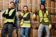 © LIGHTFIELD STUDIOS - Young volunteers in gloves and safety vests sorting waste next to a pile of boxes.
