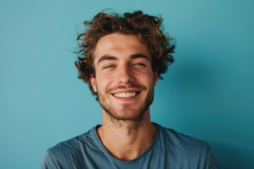 A close up portrait of a young man with a subtle smile
